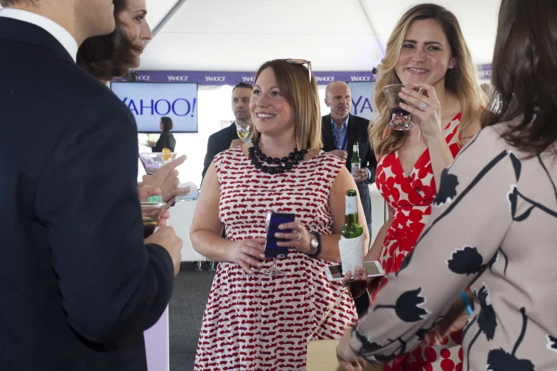 women with drinks talking to one another