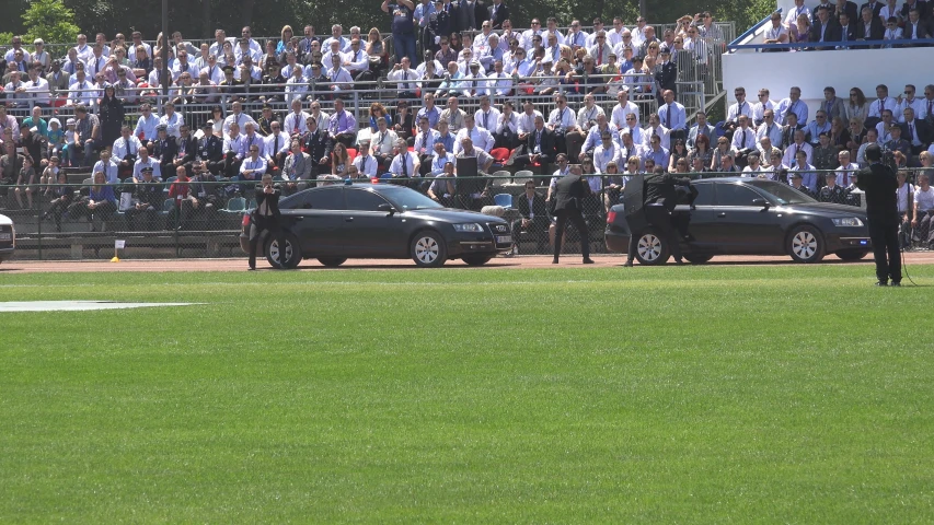 a baseball game with police cars parked near a stand