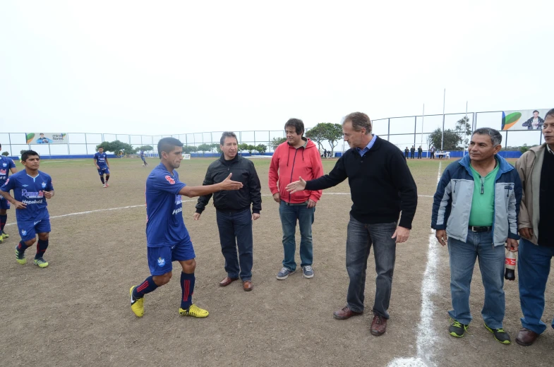 a group of people are on a field playing soccer