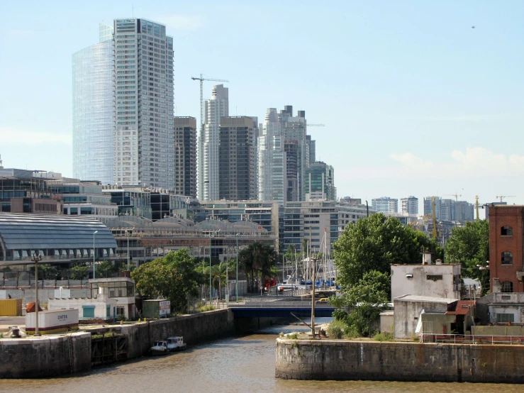 a waterway with small docks and a city in the background