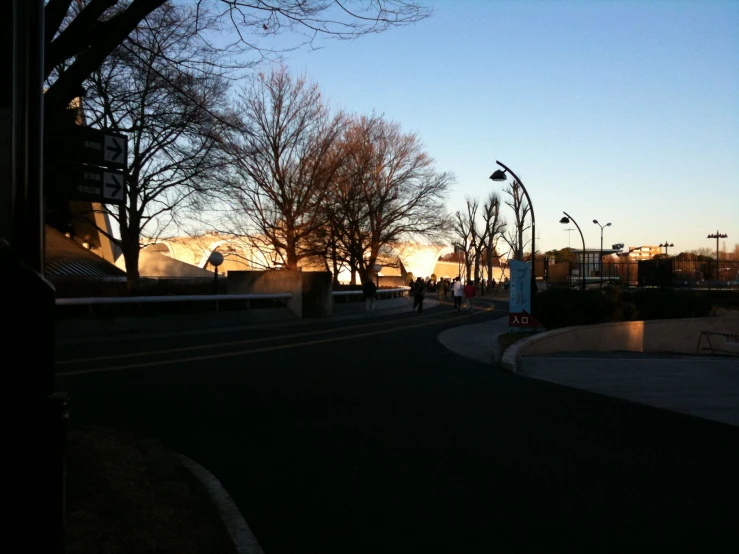 an empty street with people walking down the road