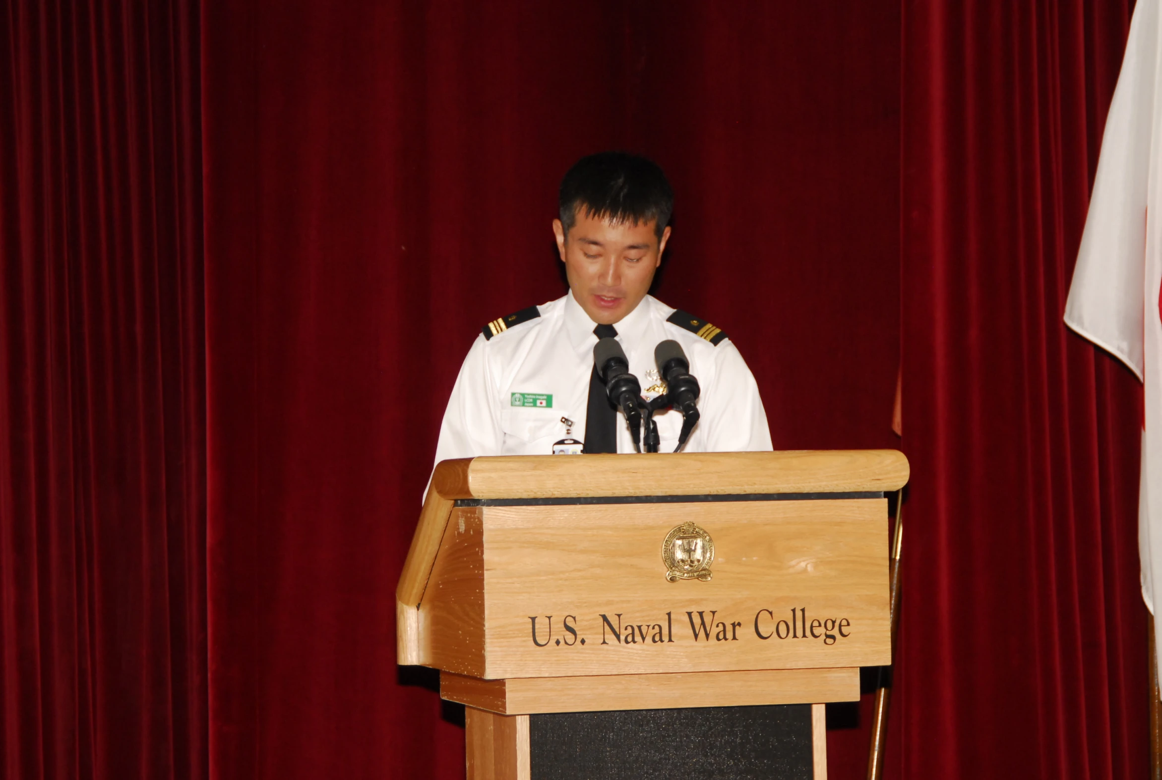 a man in a uniform is at a podium