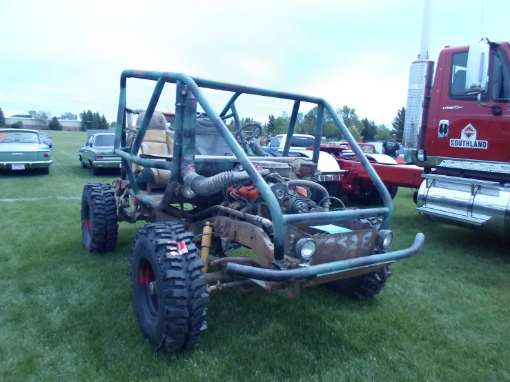 large tractor and buggy in a grassy field