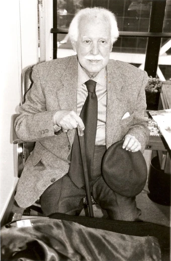 a person sitting in a chair holding a tie
