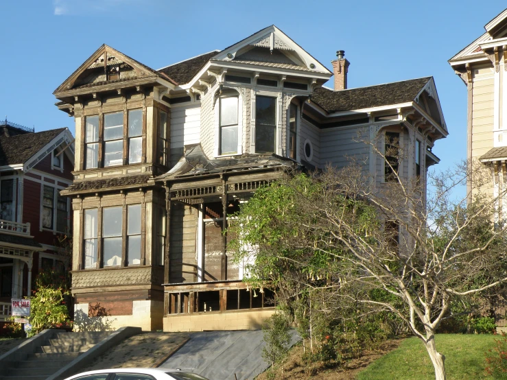 a house is shown on the corner with cars parked in front of it