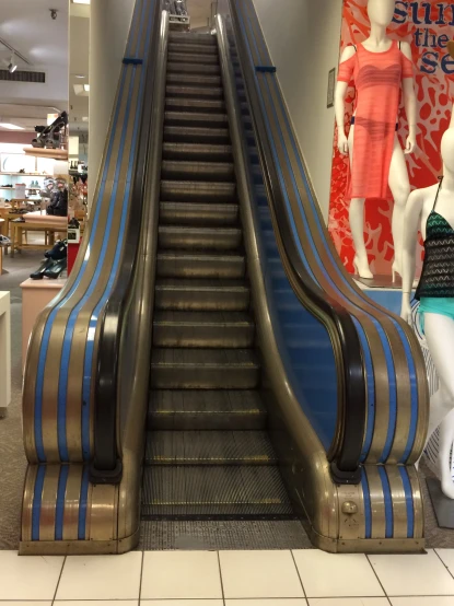 a store that has a large escalator with an empty chair