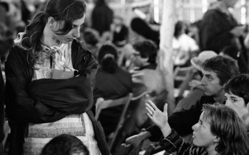 people sitting together and one holding her hand up