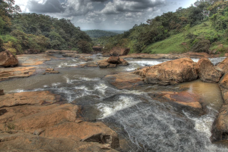 a river runs down rocks into the water