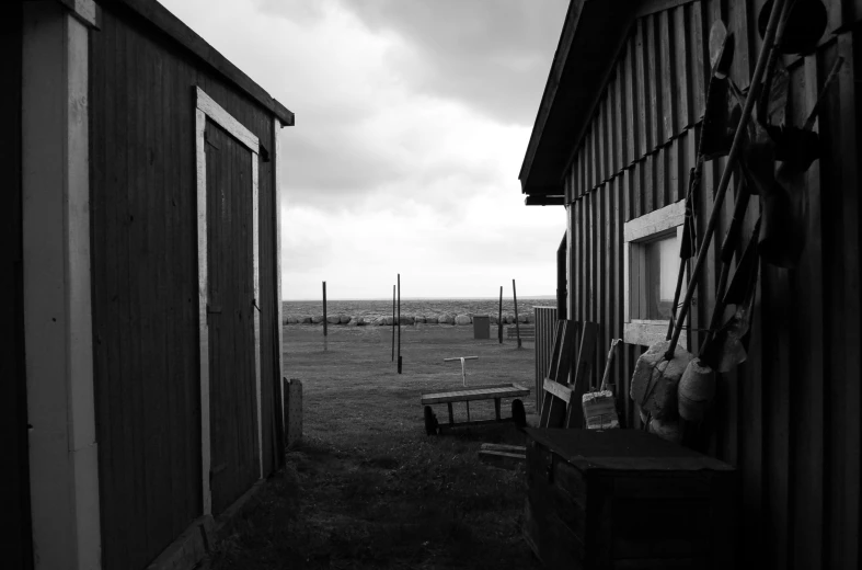 the view from behind a barn on an empty field