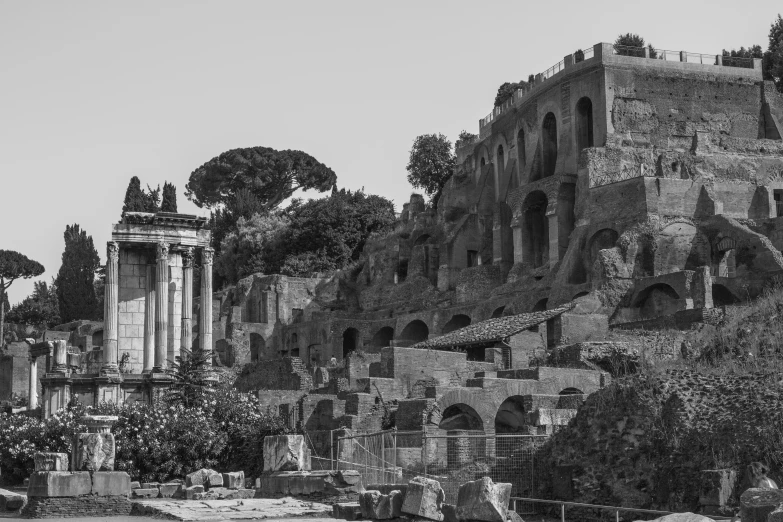 a stone building surrounded by trees and ruins