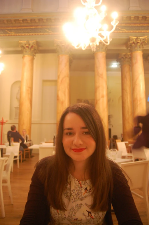 a woman with long brown hair smiles for the camera