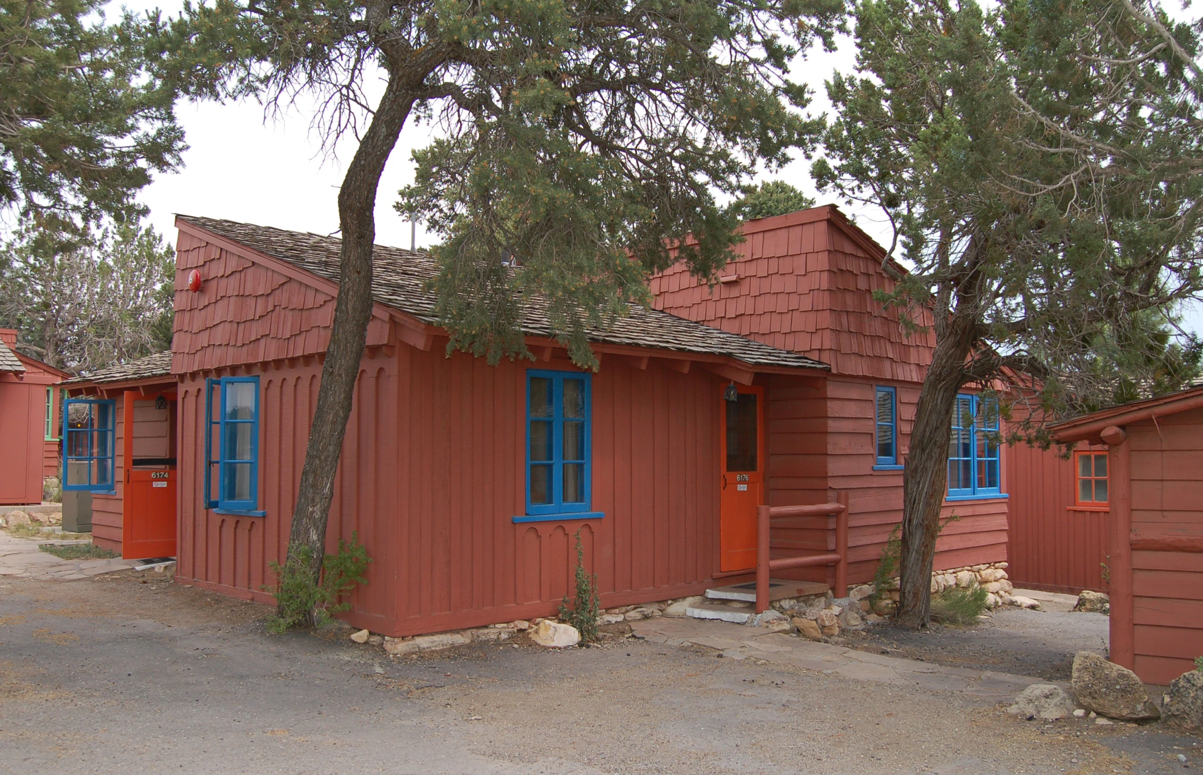 a small wooden house that has blue trim