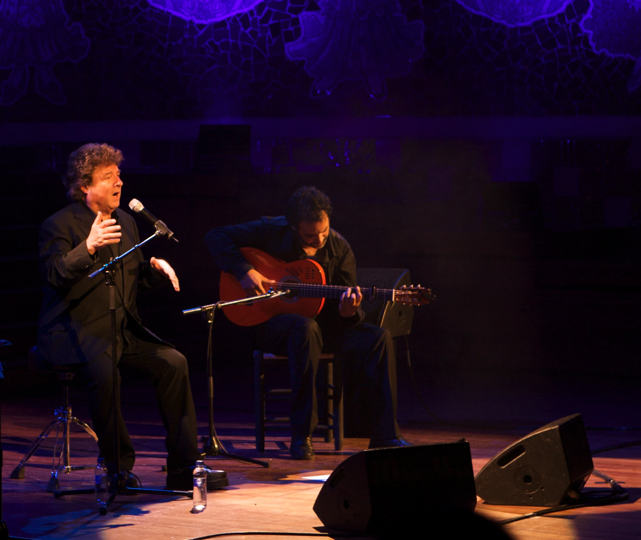 the two musicians are on stage playing instruments