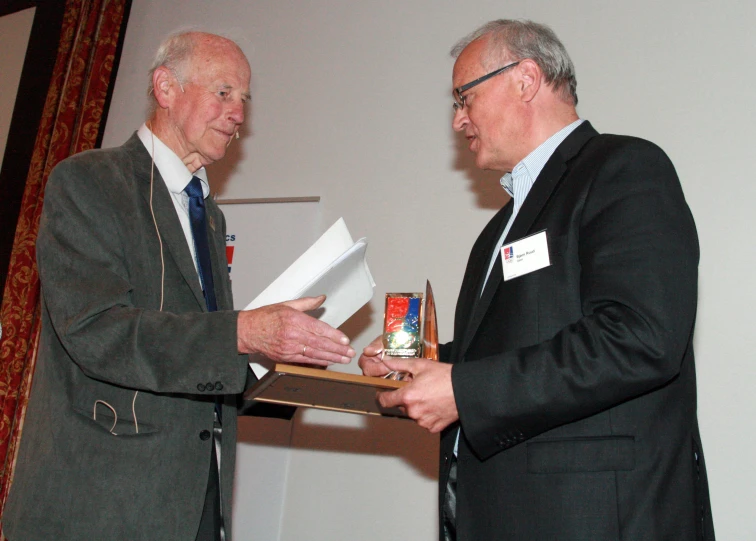 two men who are shaking hands at an event