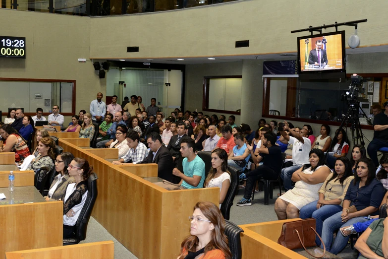 a crowd of people in large lecture hall