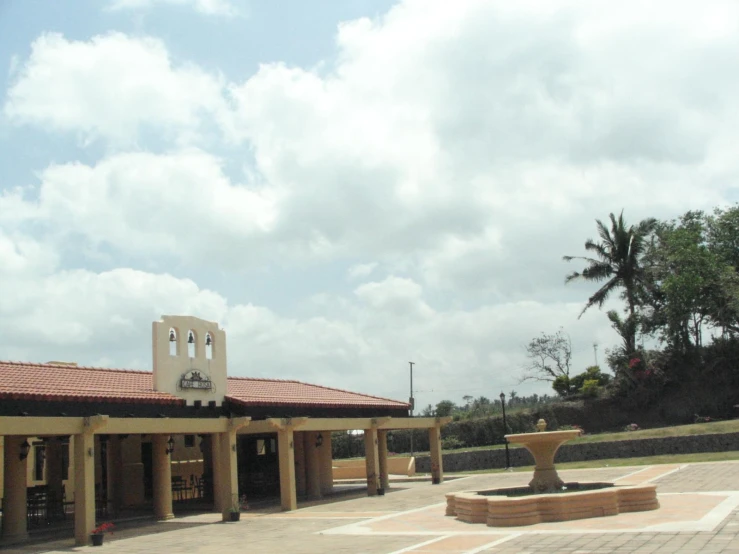 a church with an open entry way under a cloudy sky