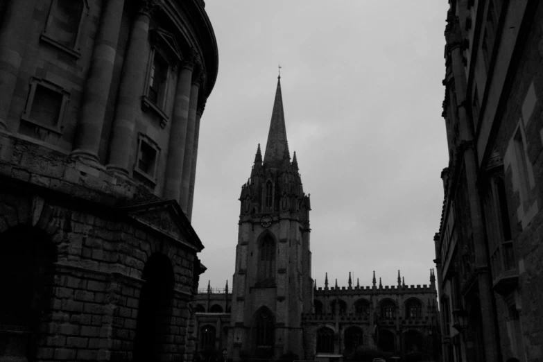 a clock tower standing in the middle of a courtyard