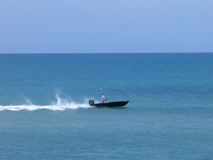 two men in a boat riding the ocean