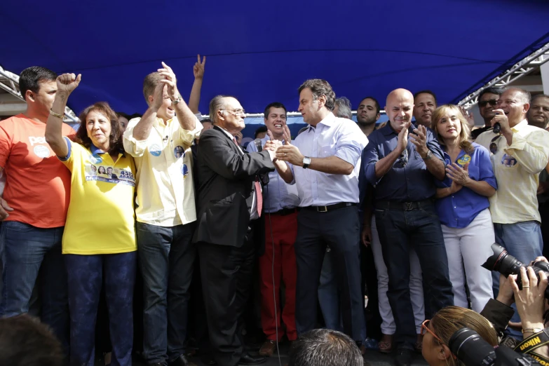 a group of people holding their hands up in a crowd