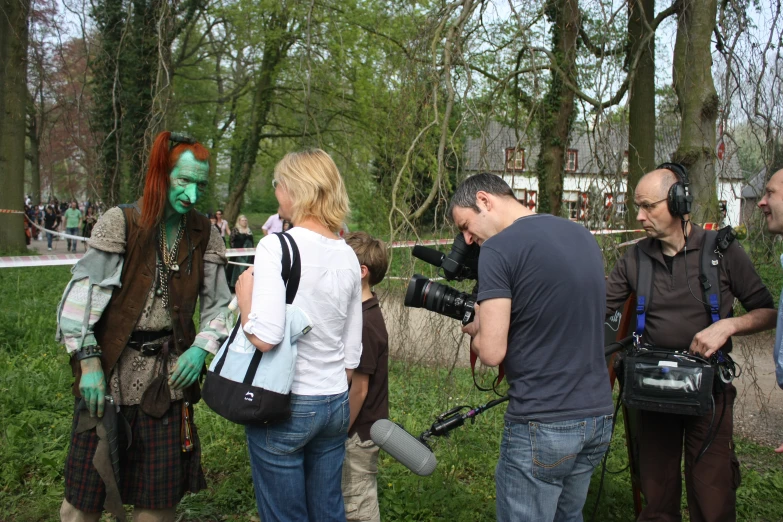 four people are standing around with camera equipment