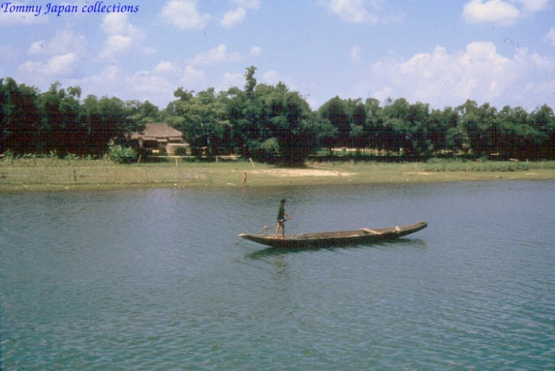 a person is paddling their canoe across the water
