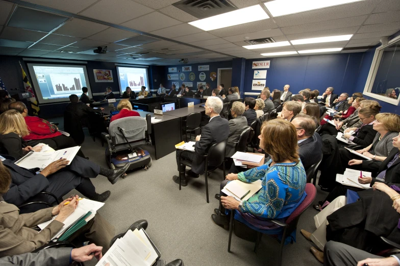 a group of people sitting in a large room