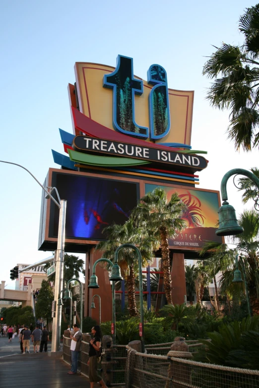 people walk down a boardwalk and pass a sign for a  island restaurant