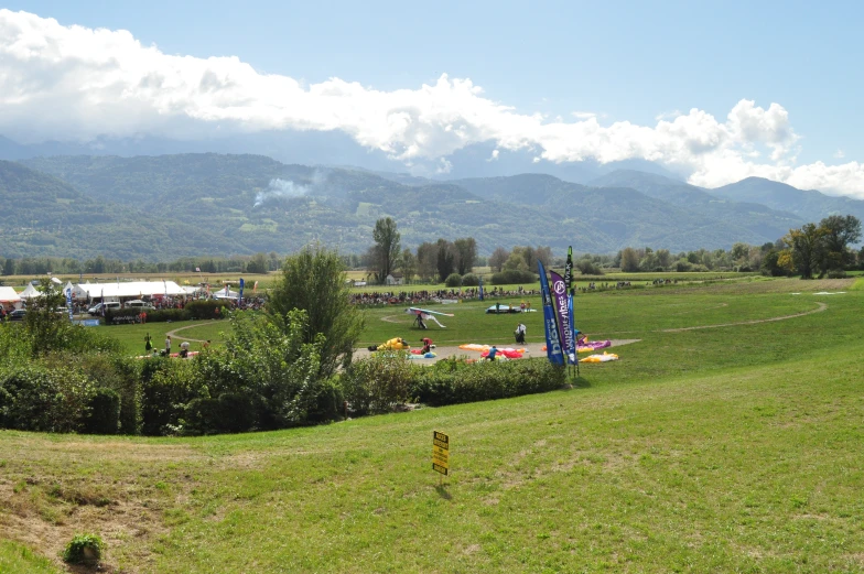 a field with people sitting on green seats