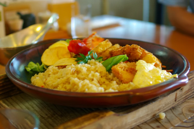 a small bowl filled with rice and various vegetables