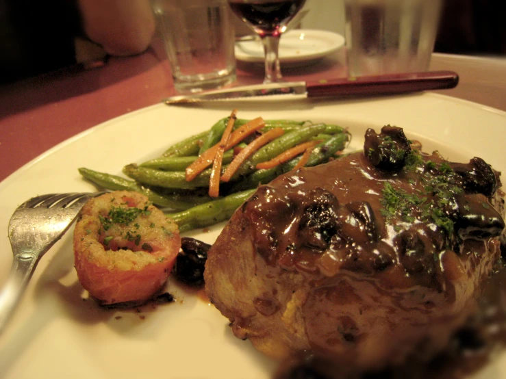 steak and green beans sit on a plate