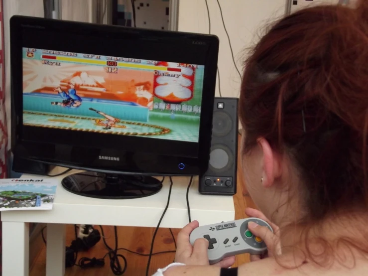 a lady in her living room playing a video game