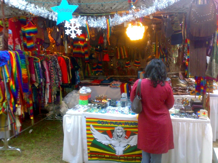 an indian girl at her market stall for clothing