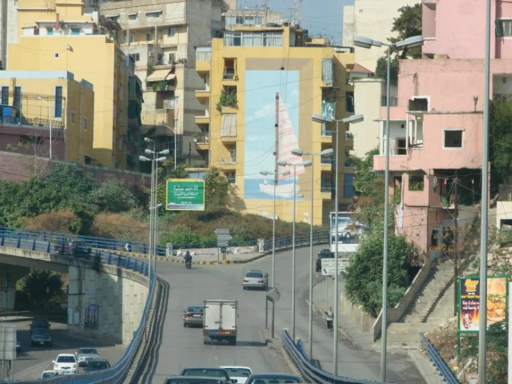 the city street is busy with cars and buses