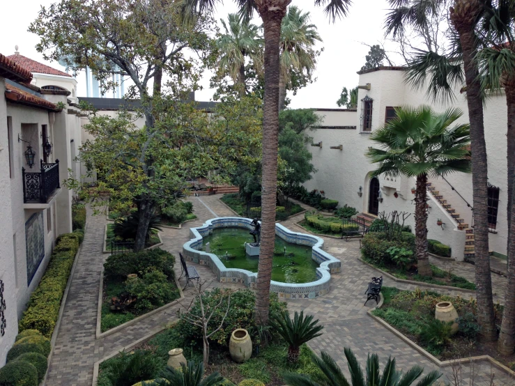 an aerial view of a courtyard garden and pool in the area