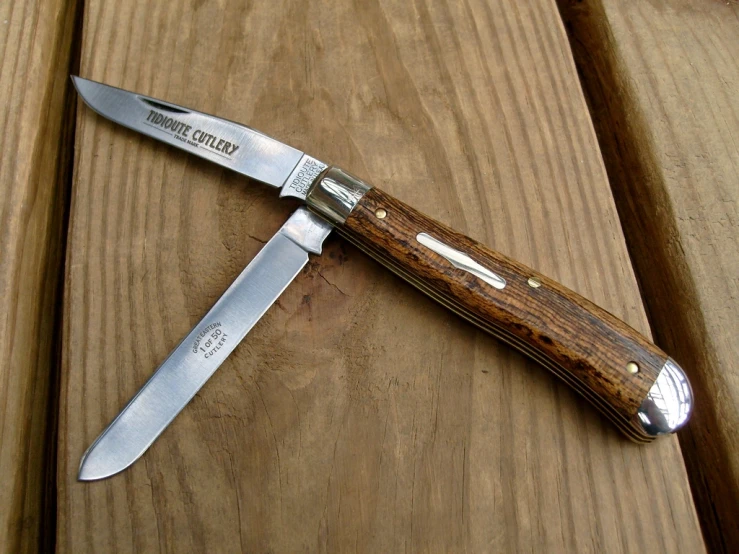 a small knife is sitting on a wooden table