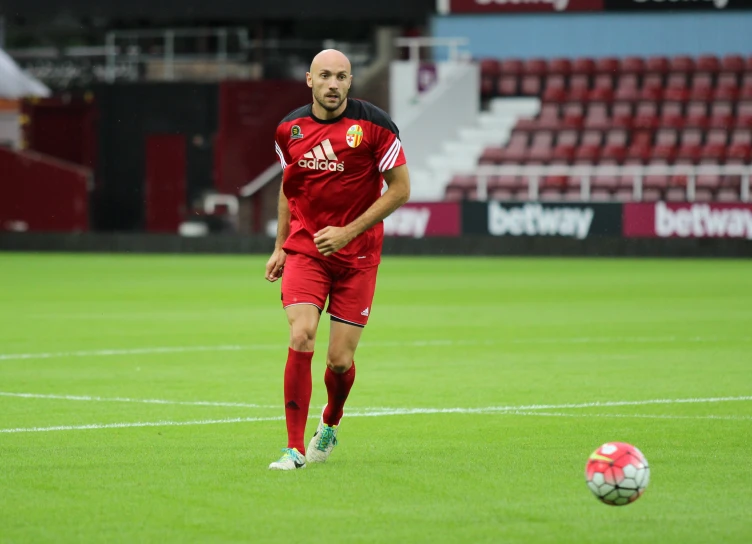 a man is on the field playing with a soccer ball