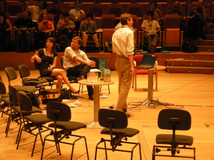 several people are standing in front of an empty stage