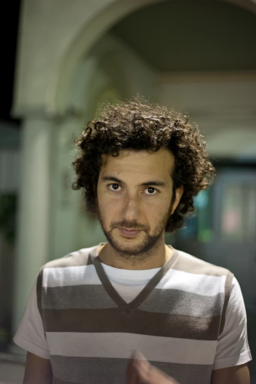 a man with a beard and a white t - shirt