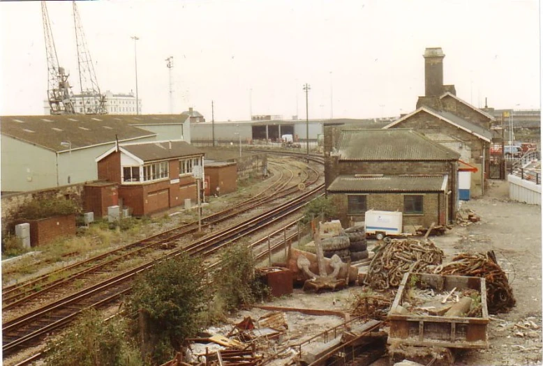 several rusty railroad tracks running next to a city