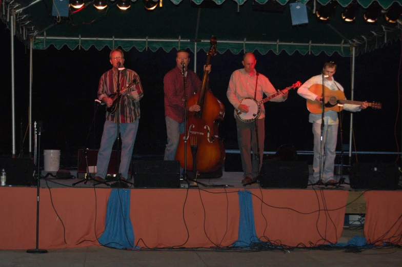 a band plays for a crowd at night