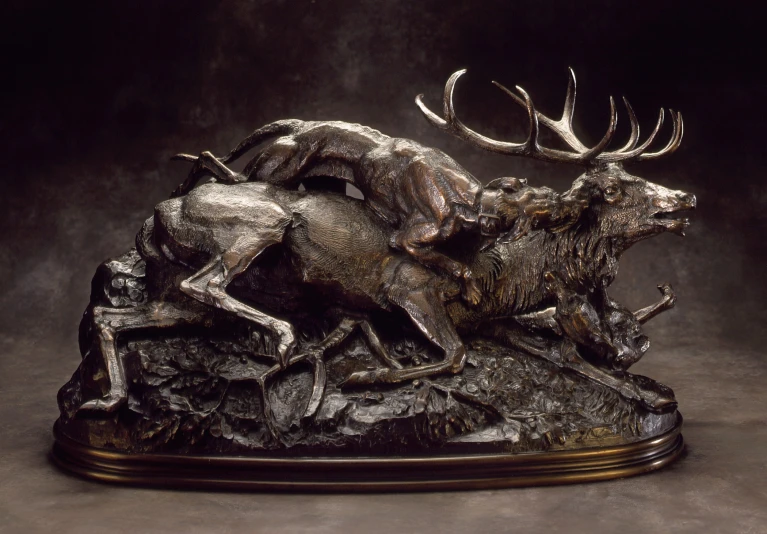 a bronze statue of two buck fighting each other