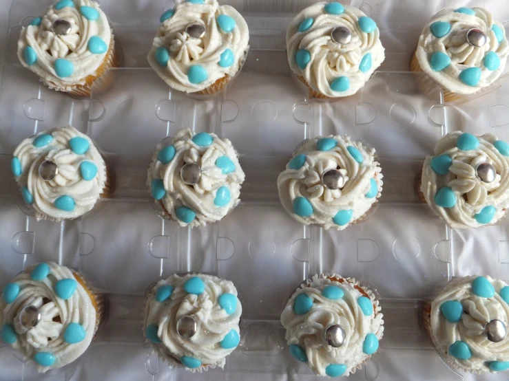 a bunch of cupcakes sitting on top of a cooling rack