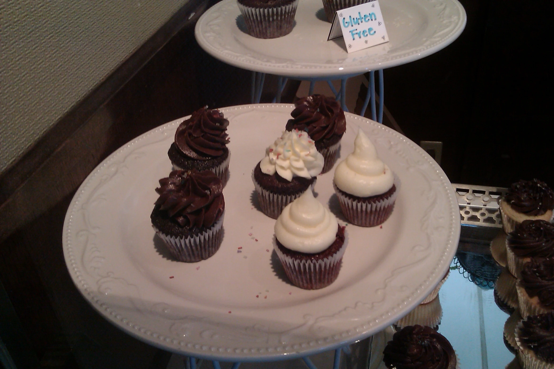 several trays filled with cupcakes on top of each other