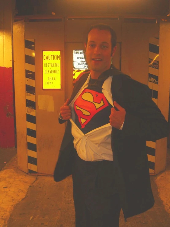 man in a suit and a superman shirt