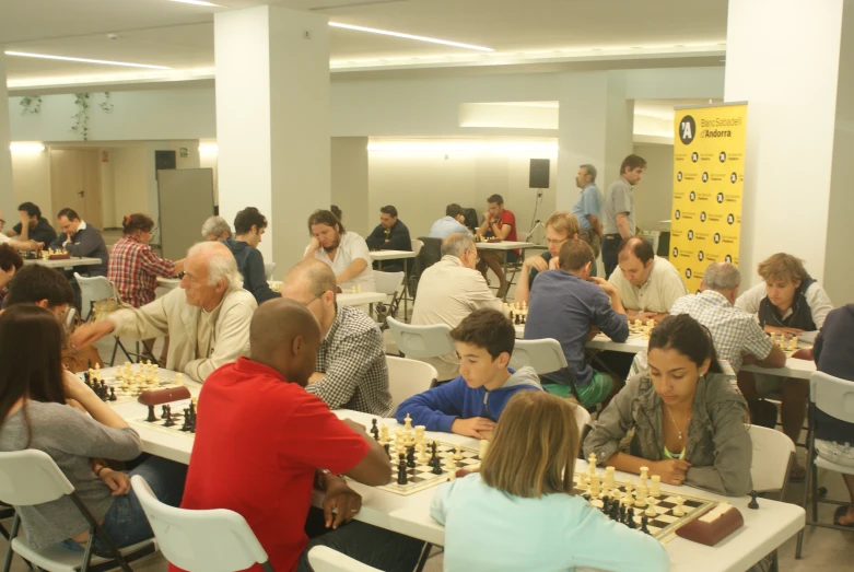 a chess match in a big room with the players playing