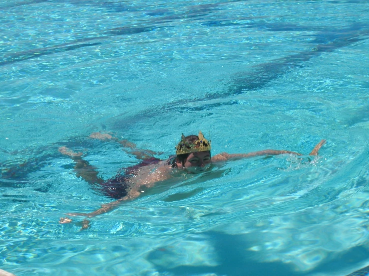 man swimming in a pool with a mask on