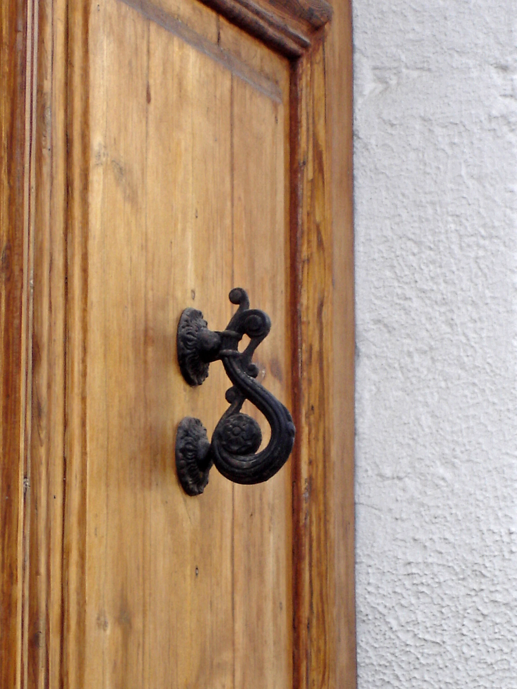 a black handle on a wooden door