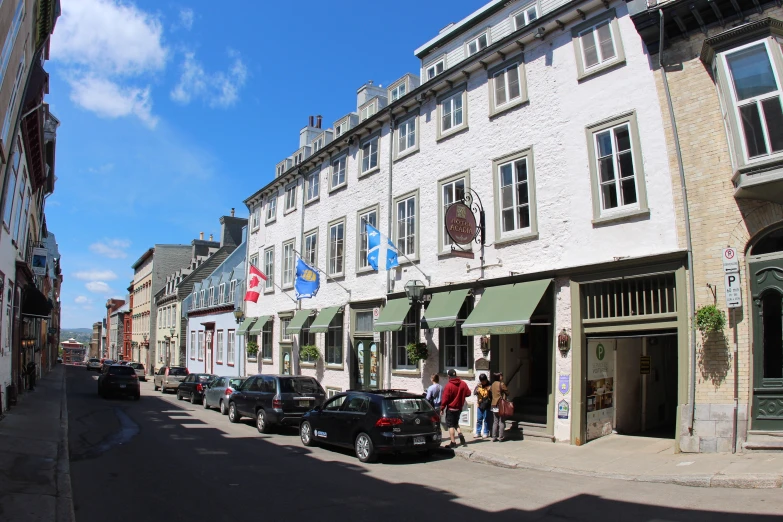 a street that has some cars parked outside the shops