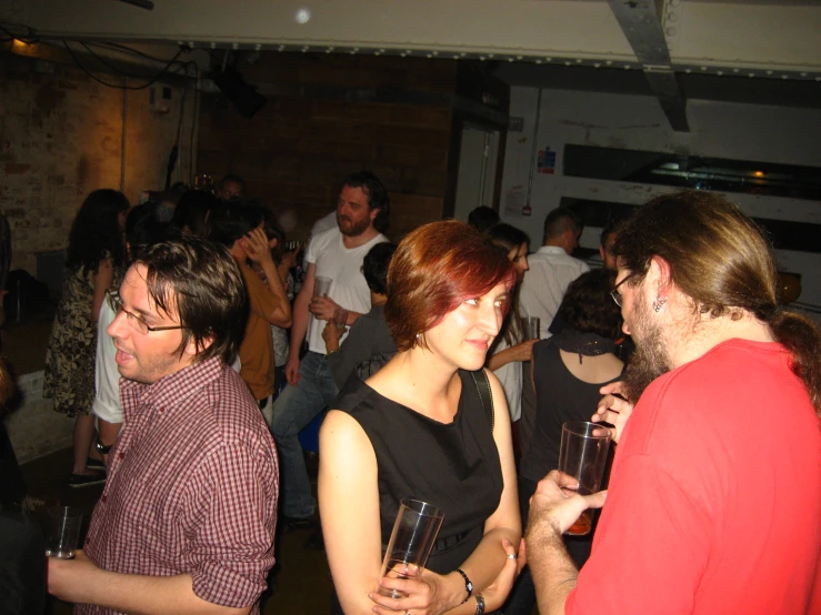 people are gathering in a bar with drinks