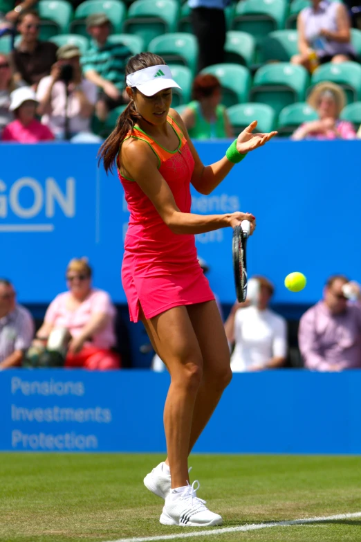 a woman in pink swinging a tennis racket